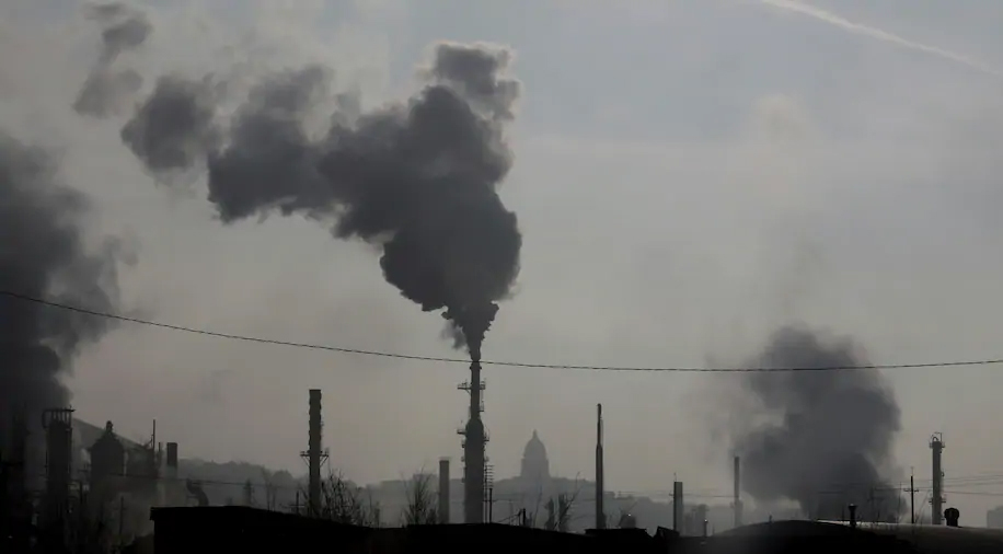 Smokestacks near an oil refinery in front of the Utah State Capitol in Salt Lake City. (Rick Bowmer/AP)